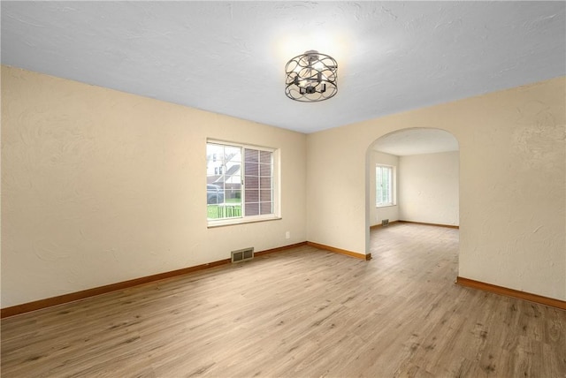 533 Freeport Rd, New Kensington, PA 15068 - spare room featuring arched walkways, wood finished floors, baseboards, and a textured wall
