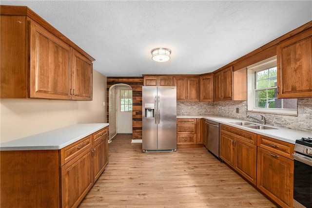 533 Freeport Rd, New Kensington, PA 15068 - kitchen featuring stainless steel appliances, a sink, light wood finished floors, brown cabinetry, and healthy amount of natural light