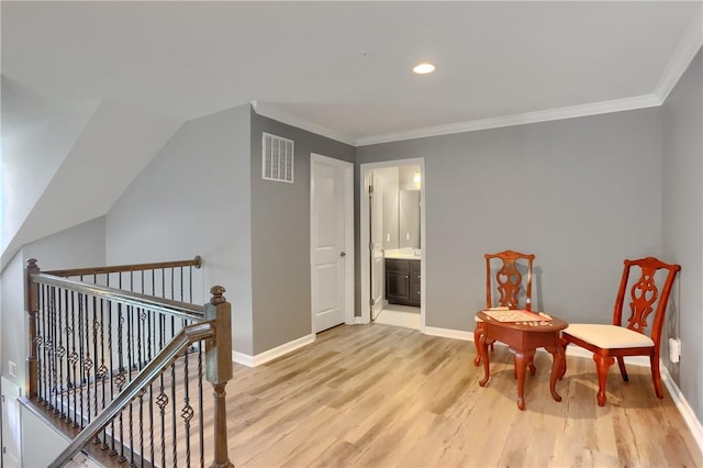 sitting room featuring an upstairs landing, light wood finished floors, ornamental molding, baseboards, and recessed lighting