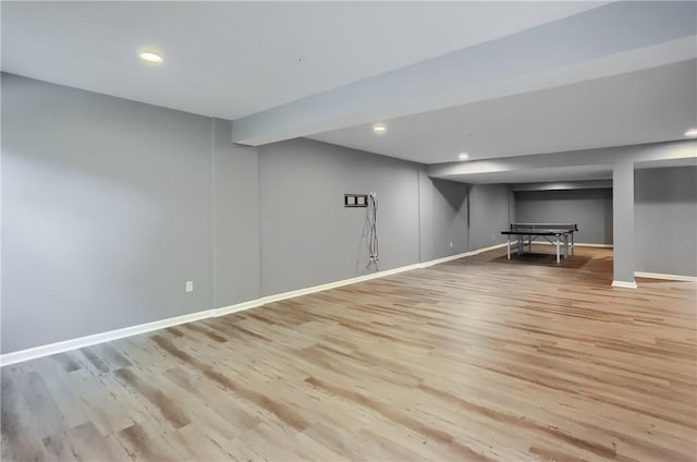 finished below grade area featuring wood finished floors, baseboards, and recessed lighting