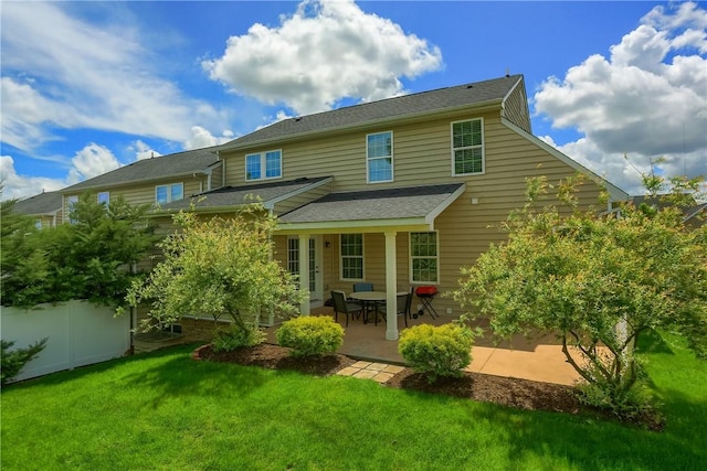 rear view of property with a patio and a shingled roof