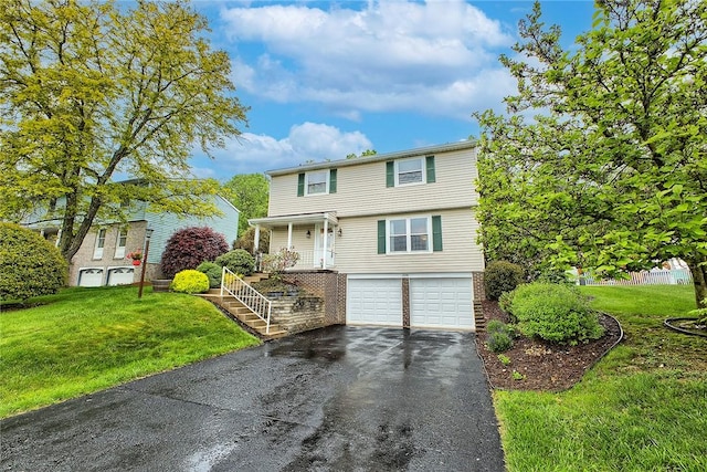 view of front facade featuring asphalt driveway, a garage, a front lawn, and covered porch