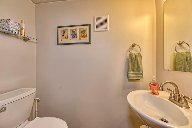half bathroom with a sink and toilet