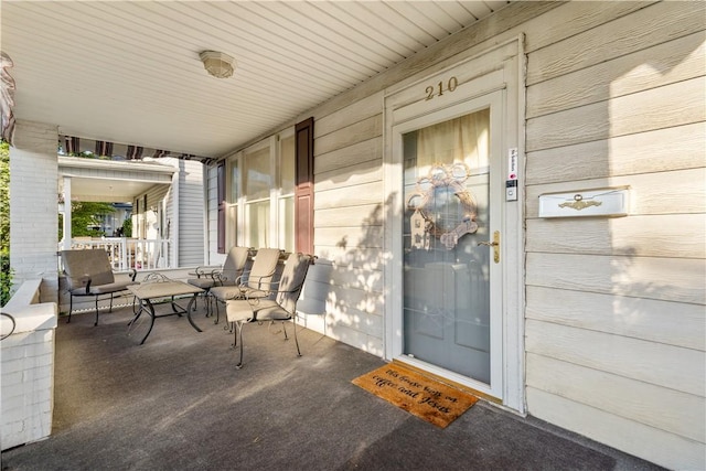 view of exterior entry with covered porch