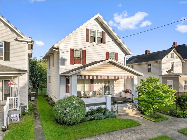 back of property with covered porch