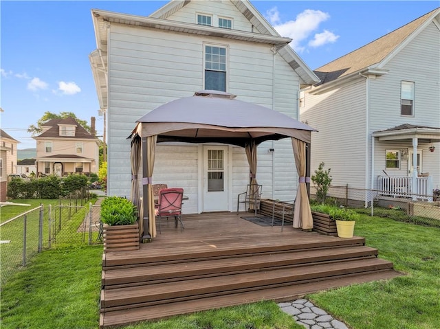 rear view of house featuring a gazebo and a deck