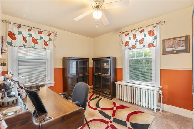 home office with radiator, carpet, ceiling fan, and baseboards
