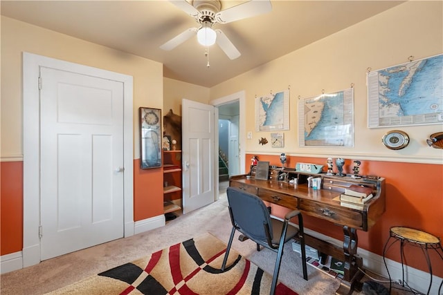 office featuring light colored carpet, baseboards, and ceiling fan