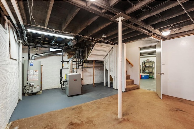 unfinished below grade area with gas water heater, stairway, and a heating unit