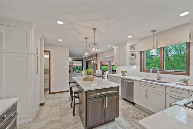 304 Diana Dr, Robinson Twp Nwa, PA 15136 - kitchen with stainless steel dishwasher, a sink, white cabinets, plenty of natural light, and recessed lighting