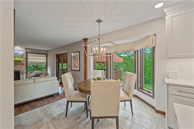 304 Diana Dr, Robinson Twp Nwa, PA 15136 - dining area with light marble finish flooring, a chandelier, and baseboards