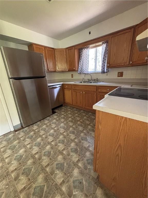 6103 Brownsville Rd, South Park, PA 15236 - kitchen with appliances with stainless steel finishes, a sink, brown cabinets, light countertops, and stone finish floors