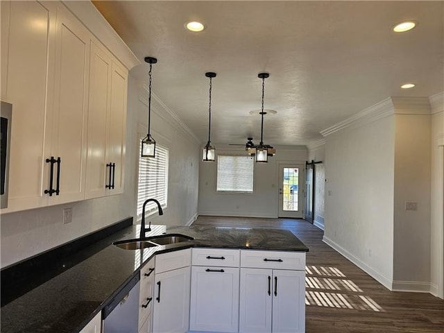 kitchen featuring a sink, crown molding, dishwasher, dark wood-style flooring, and white cabinets