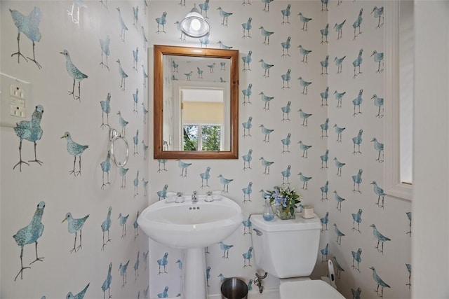 bathroom with wallpapered walls and toilet