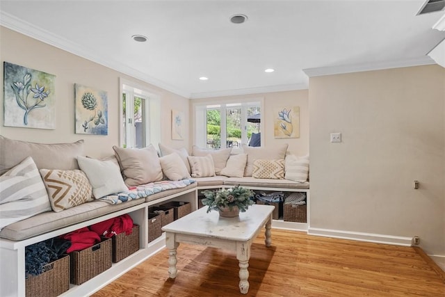 living area featuring crown molding, wood finished floors, baseboards, and recessed lighting