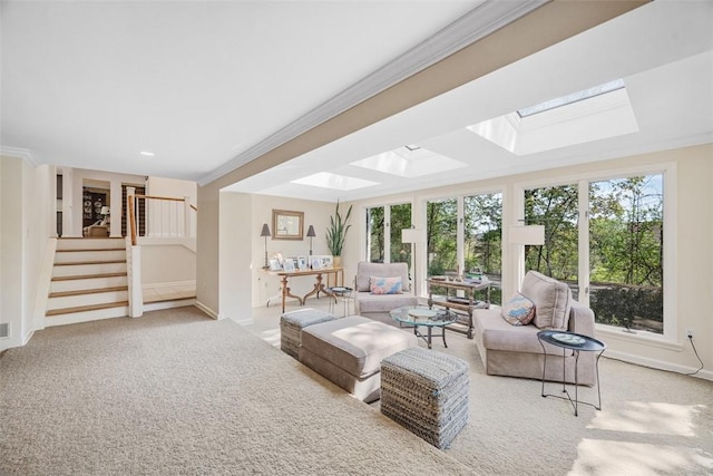 living room featuring a skylight, crown molding, stairs, carpet floors, and baseboards