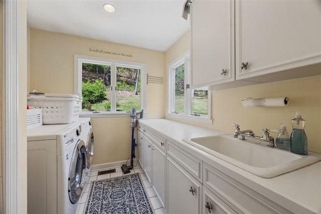 clothes washing area with cabinet space, washer and clothes dryer, light tile patterned floors, baseboards, and recessed lighting