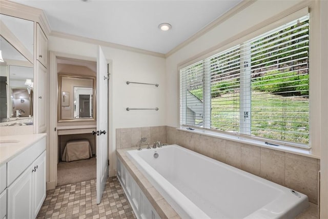 bathroom featuring vanity, a garden tub, ornamental molding, and ensuite bath
