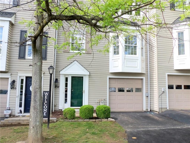 view of property featuring a garage and driveway