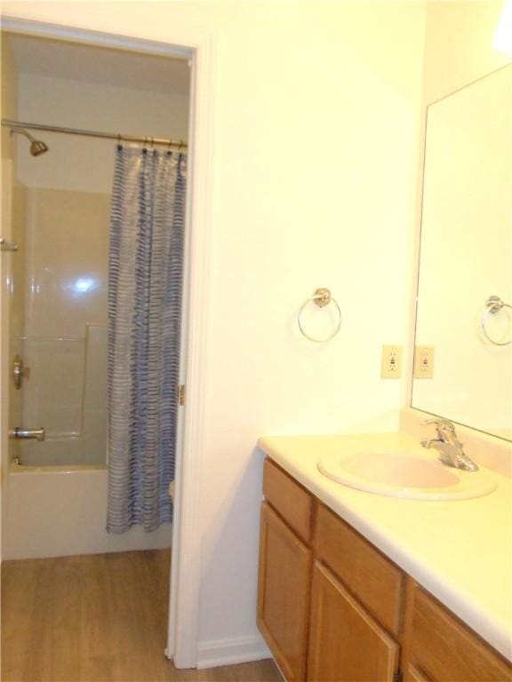 bathroom featuring vanity and shower / bath combination with curtain