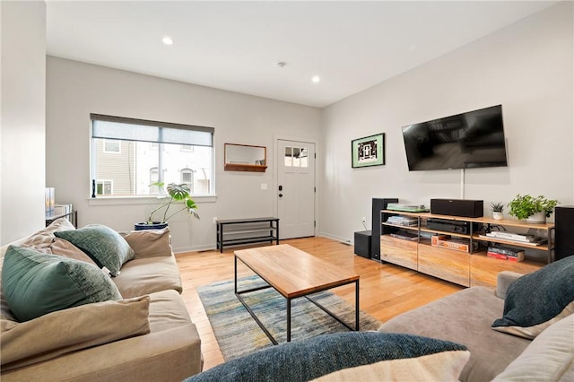 living room featuring light wood-type flooring, recessed lighting, and baseboards