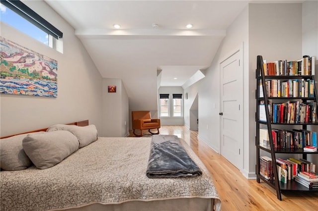 bedroom with light wood-type flooring, multiple windows, lofted ceiling, and recessed lighting