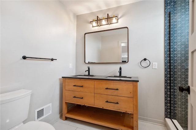 full bath with toilet, double vanity, a stall shower, and baseboards