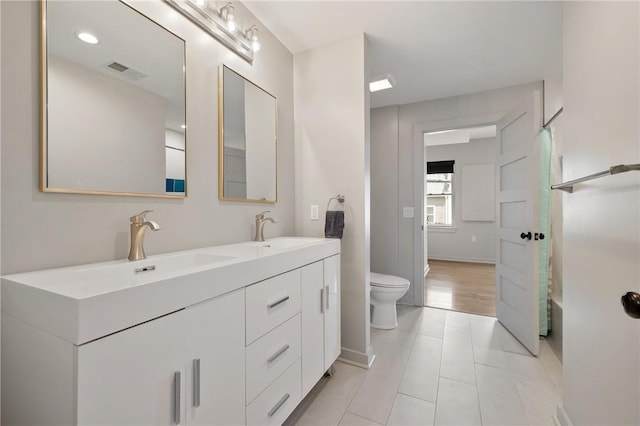 full bathroom with toilet, double vanity, tile patterned floors, and curtained shower