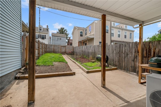 view of patio / terrace with a fenced backyard, a residential view, ac unit, and a grill