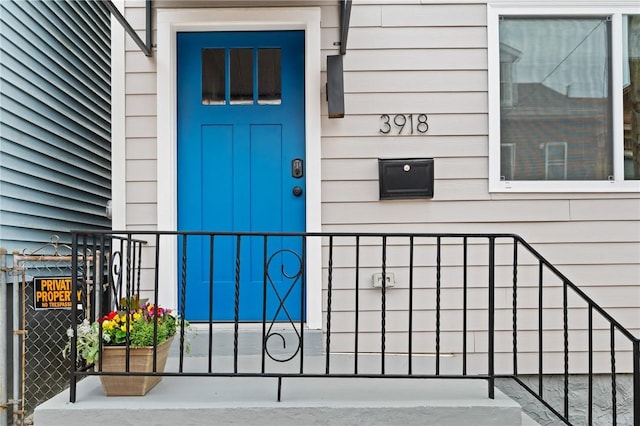 entrance to property featuring fence