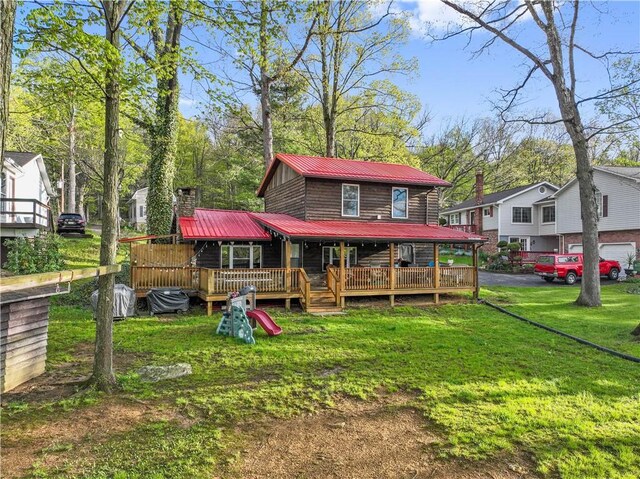 1036 Causeway Dr, Lake Stonycreek, PA 15541 - back of property featuring metal roof, a lawn, driveway, and a chimney