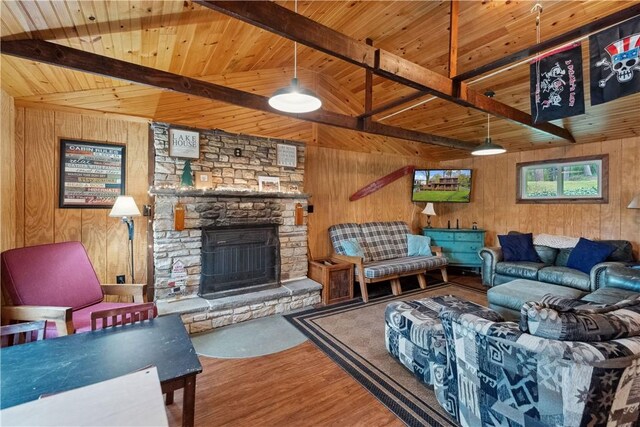 1036 Causeway Dr, Lake Stonycreek, PA 15541 - living area featuring wood finished floors, beam ceiling, wooden walls, wooden ceiling, and a stone fireplace