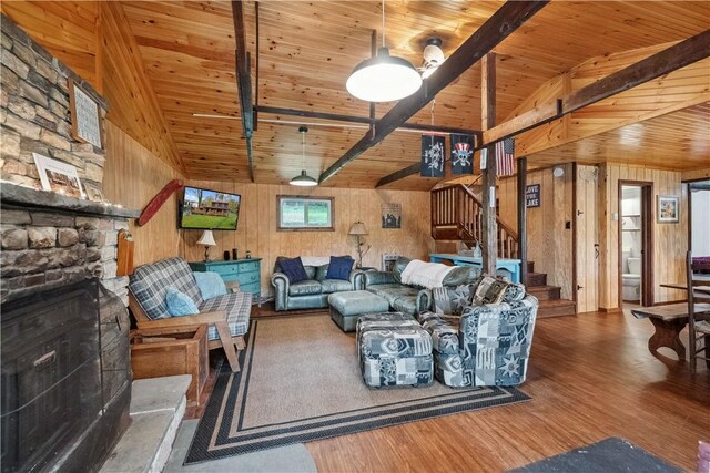 1036 Causeway Dr, Lake Stonycreek, PA 15541 - living area with a stone fireplace, stairway, wood finished floors, wooden walls, and wood ceiling