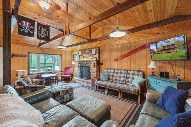 1036 Causeway Dr, Lake Stonycreek, PA 15541 - carpeted living room with wooden walls, wood ceiling, beamed ceiling, a stone fireplace, and ceiling fan