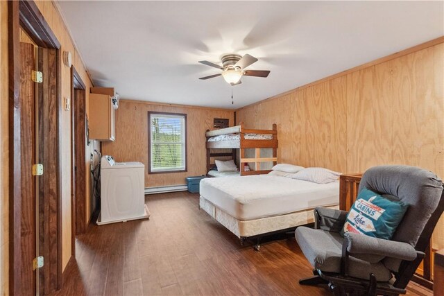 1036 Causeway Dr, Lake Stonycreek, PA 15541 - bedroom with washing machine and dryer, wood finished floors, a baseboard heating unit, wood walls, and ceiling fan