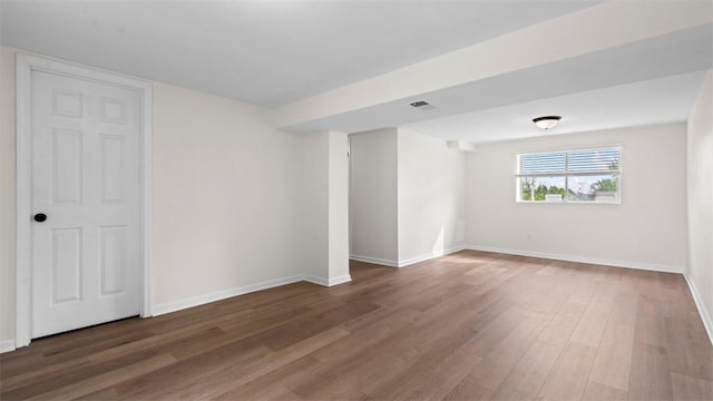 unfurnished room with wood finished floors and baseboards