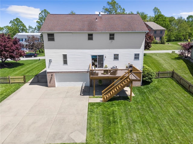 rear view of property featuring a wooden deck, a garage, stairs, and driveway