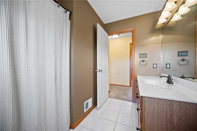 bathroom featuring baseboards, vanity, tile patterned floors, and a chandelier