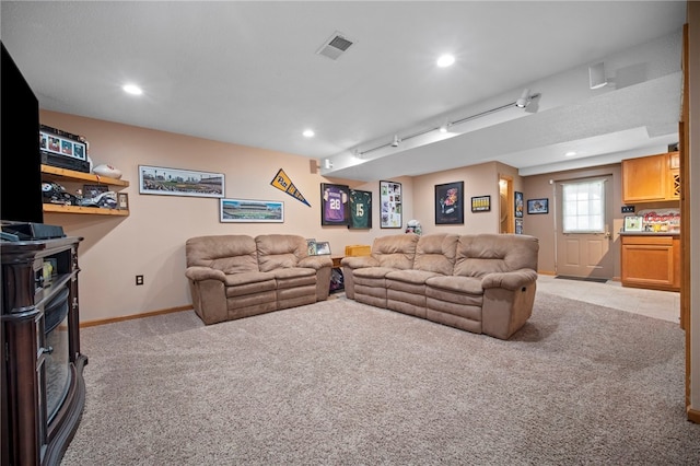 living room featuring light carpet, baseboards, recessed lighting, and a wood stove