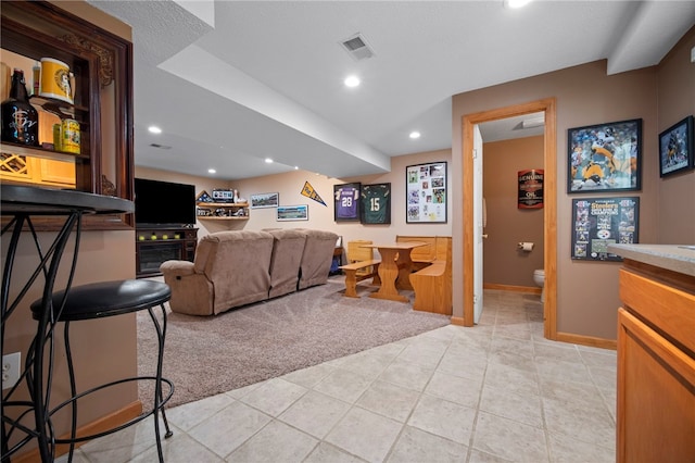 living room with light carpet, light tile patterned floors, baseboards, and recessed lighting