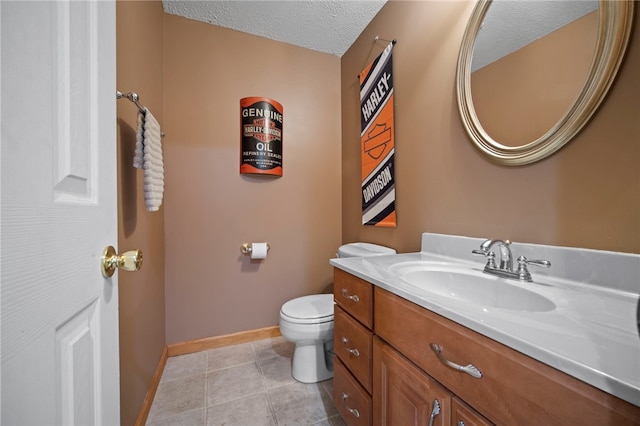 half bath with baseboards, toilet, a textured ceiling, vanity, and tile patterned floors