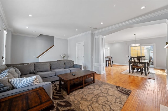 living room with light wood-style floors, recessed lighting, crown molding, and baseboards