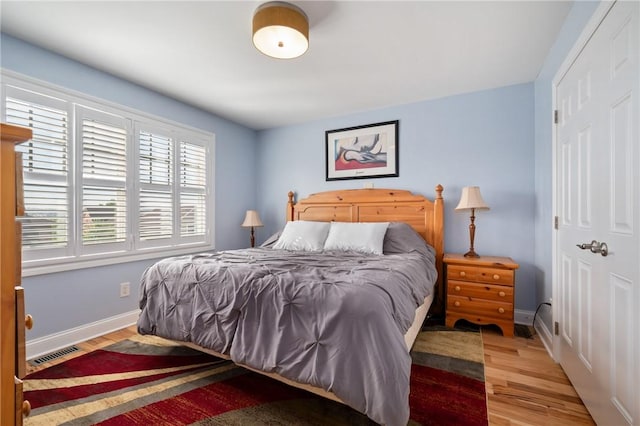 bedroom featuring wood finished floors and baseboards