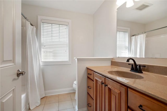 full bath with tile patterned flooring, toilet, vanity, and baseboards