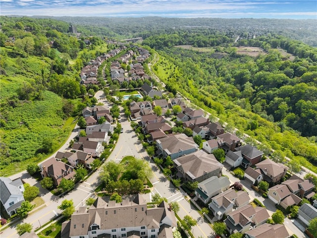 aerial view of residential area featuring a forest