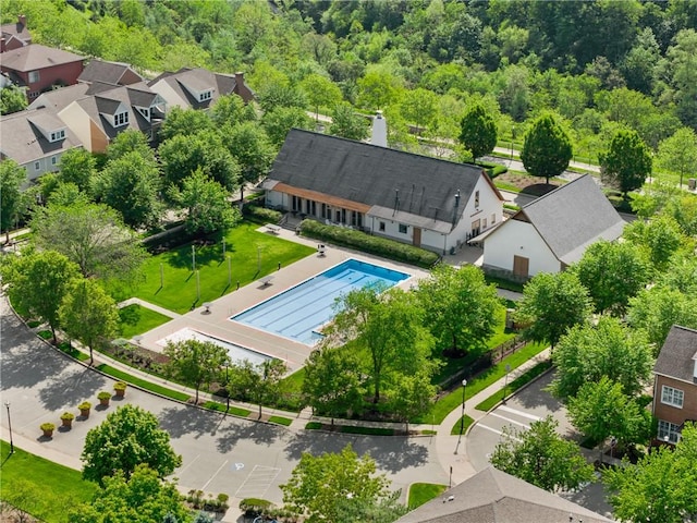 aerial perspective of suburban area featuring a pool