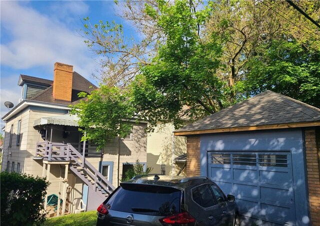 743 Taylor Ave, Avalon, PA 15202 - exterior space with a chimney, roof with shingles, a garage, and stairs