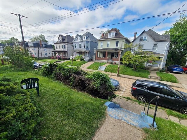 743 Taylor Ave, Avalon, PA 15202 - view of front facade with a residential view, covered porch, and a front lawn