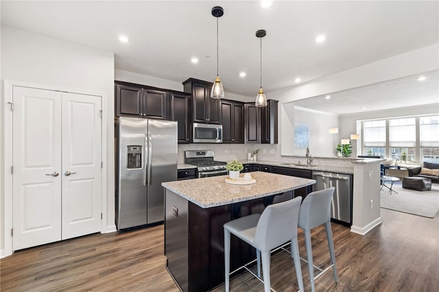 128 Cole Dr, Robinson Twp Nwa, PA 15136 - kitchen featuring stainless steel appliances, open floor plan, a peninsula, a kitchen island, and decorative backsplash