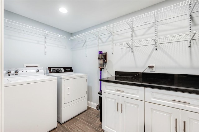 laundry room with independent washer and dryer and baseboards